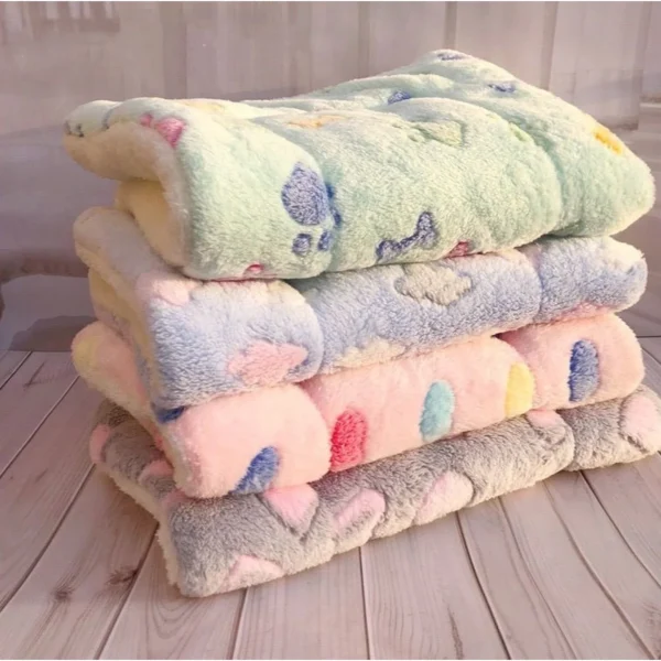 Padded fleece pet mats stacked in four prints